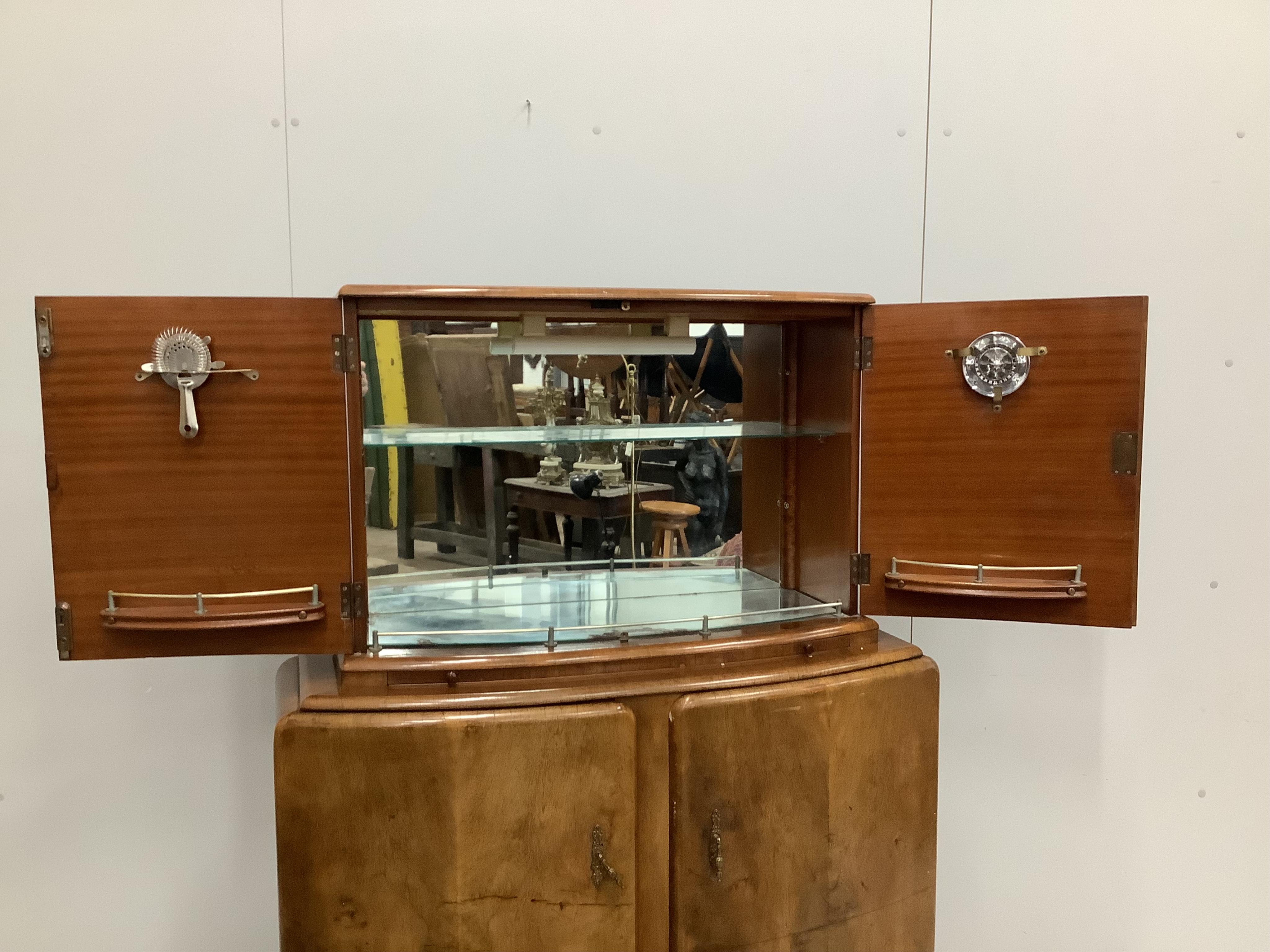 An Art Deco style walnut cocktail cabinet, width 102cm, depth 38cm, height 144cm. Condition - fair